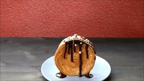 Footage of Hand Sprinkling Chopped Nuts on a Delectable Chocolate Supreme Croissant - Powered by Shutterstock - Get 15% off with code: PIKWIZARD15