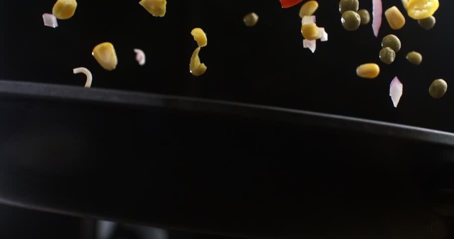 Super slow motion of asian noodles and vegetables flipping in pan to be cooked with traditional recipes for dish preparation by chef in restaurant kitchen at 1000 fps.