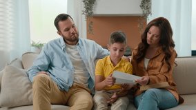 Upset shocked Caucasian family reading bad news on couch at home disappointed father mother son receiving paper letter school notification child kid boy receive refusal to education warning notice - Powered by Shutterstock - Get 15% off with code: PIKWIZARD15