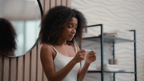 African American woman ethnic girl female biracial lady sad upset frustrated worry anxious with positive or negative pregnancy test unwanted unplanned pregnant fertility problem health in bathroom - Powered by Shutterstock - Get 15% off with code: PIKWIZARD15