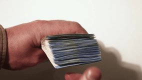 Counting a stack of money in hands. 20 euro bills. Close up stock slow motion video