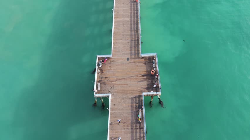 Aerial View of southern california pier with a beautful orange sunset