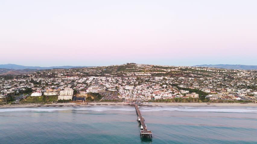 Aerial View of southern california pier with a beautful orange sunset