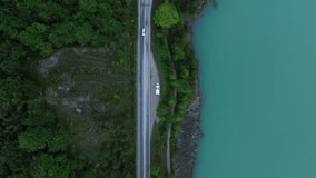 Aerial view descending over camper van parked on the side of forest lake on a road trip - Powered by Shutterstock - Get 15% off with code: PIKWIZARD15