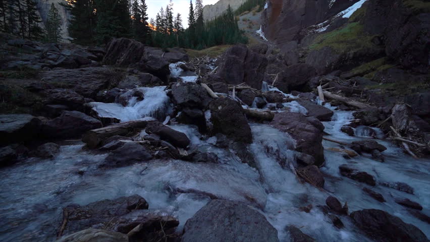 Telluride Colorado sunset stream Bridal Veil Falls frozen ice Waterfall fall autumn sunset cool shaded Rocky Mountains Silverton Ouray Millon Dollar Highway historic town scenic landscape slow pan up