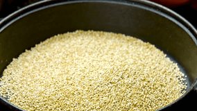 Crisp 4K Ultra HD Video: Close-Up of Fresh Quinoa Cooking in a Pan | Nutritious Whole Grain Delight