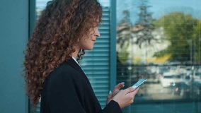 Side view Caucasian businesswoman elegant girl in suit walking street in city young business woman employer going looking at mobile phone screen chatting online social media using smartphone outdoors - Powered by Shutterstock - Get 15% off with code: PIKWIZARD15