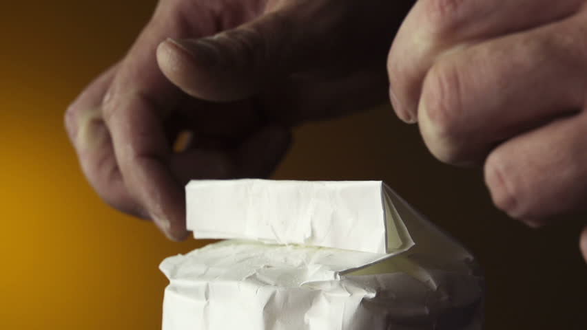 Hands opening package of flour