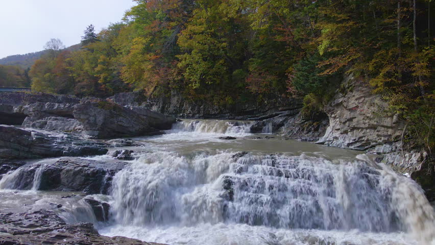 Cinematic aerial shot of Sandandaki Waterfall in Furano City in Hokkaido, Japan Royalty-Free Stock Footage #3435516129