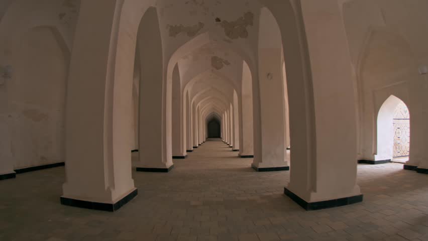 Passage between columns and arches in the Mir-i-Arab Madrasa complex. Royalty-Free Stock Footage #3435567765