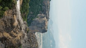 Vertical video. Meteora, Kalabaka, Greece. Monastery of the Holy Trinity at Meteora. Meteora - rocks, up to 600 meters high. There are 6 active Greek Orthodox monasteries listed on the UNESCO list, A