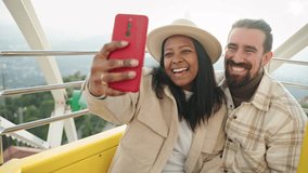 Romantic couple in love kissing and taking selfie portrait on cell phone on ferris wheel in amusement park  - Powered by Shutterstock - Get 15% off with code: PIKWIZARD15
