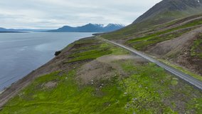 Scenic road along the ocean in Iceland. Beautiful nature of Iceland. Road among the mountains and ocean. Summer in Iceland.