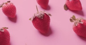 Animation of sweet text over strawberries on pink background. Fruit, healthy diet and vegan fresh food concept digitally generated video.