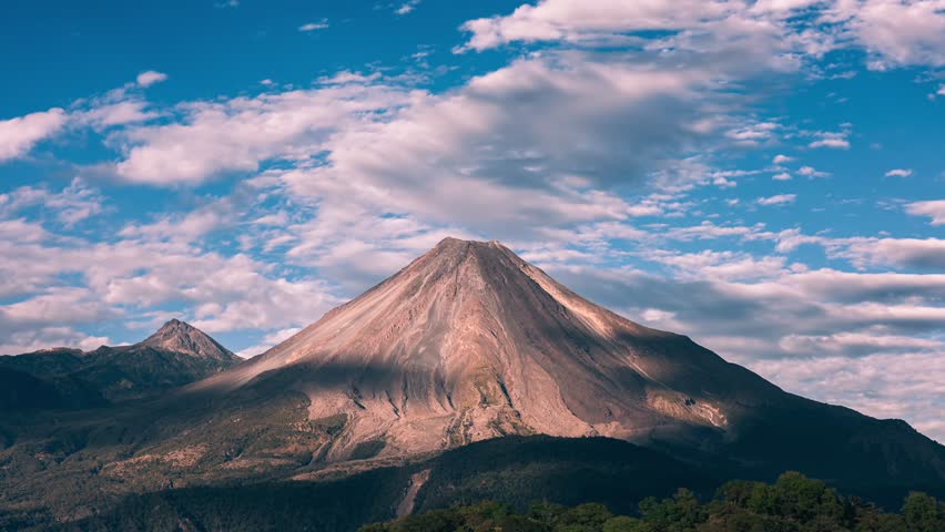 Breathtaking time-lapse over Colima's active volcano at sunset, sky turns from blue to fiery red Royalty-Free Stock Footage #3435734453