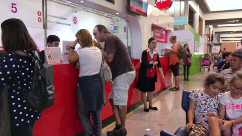 BANGKOK - DEC, 2017: People buy tickets at an AirAsia sales center at the Don Mueang International Airport. AirAsia Berhad is a Malaysian low cost airline headquartered near Kuala Lumpur, Malaysia. 
