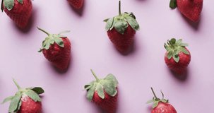 Animation of super foods text over halved strawberries on pink background. Fruit, healthy diet and vegan fresh food concept digitally generated video.