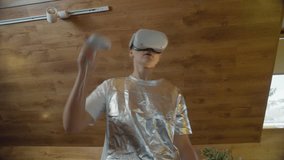 Interactive VR gaming by woman in silver outfit