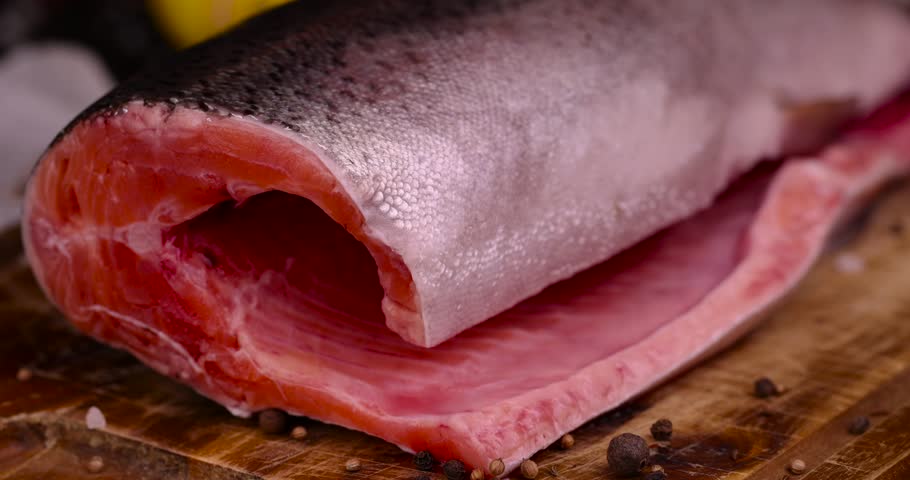 red trout meat in the kitchen, cooking a fish dish with expensive red salmon fish