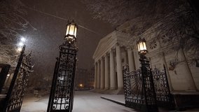 Bucharest night snowfall full HD slow motion video 100fps. Amazing video with massive snow falling from sky during the night. View to Romanian Atheneum landmark building.