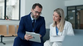 Pharmaceutical sales representative talking with doctor in medical building. Female doctor talking with hospital director, manager in private clinic. - Powered by Shutterstock - Get 15% off with code: PIKWIZARD15