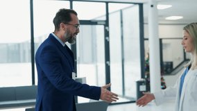 Pharmaceutical sales representative talking with doctor in medical building. Ambitious male sales representative presenting new medication on tablet. - Powered by Shutterstock - Get 15% off with code: PIKWIZARD15