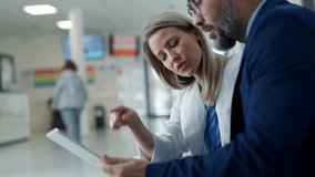 Pharmaceutical sales representative talking with doctor in medical building. Female doctor talking with hospital director, manager in private clinic. - Powered by Shutterstock - Get 15% off with code: PIKWIZARD15