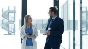 Pharmaceutical sales representative talking with doctor in medical building. Ambitious male sales representative presenting new medication. - Powered by Shutterstock - Get 15% off with code: PIKWIZARD15
