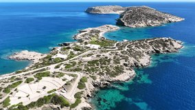 Aerial drone video of paradise secluded beach and bay of Agios Vasileios located in long peninsula of small island of Schoinousa, Small Cyclades, Greece