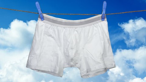 Cinemagraph - Underwear with the abstract movement on a string against cloudy sky