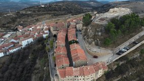 Drone video of the main street and its historic stone buildings and the castle remains of the town of Culla, in the Alto Maestrazgo of Castellon, Spain. Spanish rural tourism