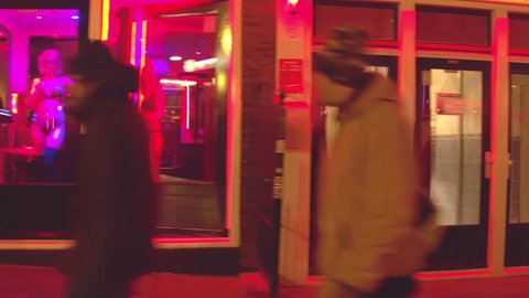 AMSTERDAM, NETHERLANDS - DECEMBER 27, 2017. Walk along prostitutes windows in famous red light district De Wallen