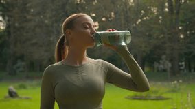 Caucasian girl fitness woman runner female drinking water with bottle in park outdoors habit refreshing body hydration smiling sportswoman hold green apple healthy vitamins sport nutrition loss weight - Powered by Shutterstock - Get 15% off with code: PIKWIZARD15