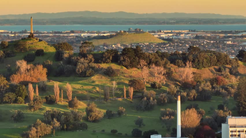 Aerial: One Tree Hill and Cornwall Park at sunset, Auckland, New Zealand.