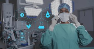 Animation of network medical icons over african american female surgeon smiling in theatre. Surgery, digital interface, connection, hospital and healthcare, digitally generated video.