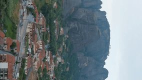 Vertical video. Meteora, Kalabaka, Greece. Meteora - rocks, up to 600 meters high. There are 6 active Greek Orthodox monasteries listed on the UNESCO list, Aerial View