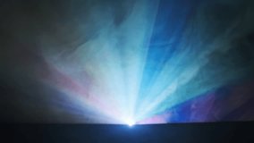 Colorful projector rays in smoke on black background. The radiant beams, enveloped in a spectrum of colors, light dispersion. Home theater, business presentation, vivid lighting effects. Searchlight