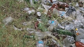 Illegal garbage dump of plastic and bottles in the forest pit. Human pollution of forests. Pile of synthetic waste in nature. Lot of different trash in wood. Rubbish thrown away on a ground by people - Powered by Shutterstock - Get 15% off with code: PIKWIZARD15