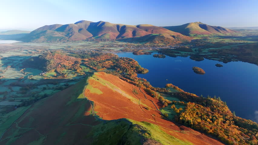 Aerial footage of Derwentwater and the Skiddaw mountain range, Keswick, Lake District National Park, Cumbria, England, United Kingdom