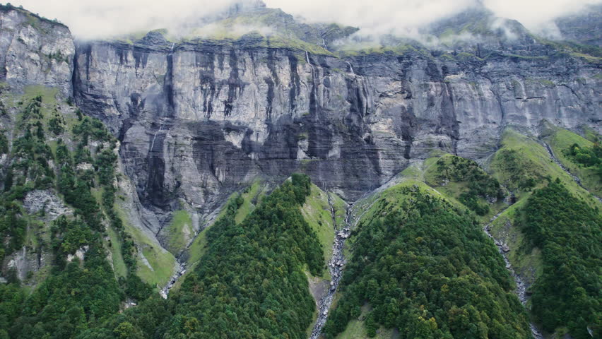 Aerial view exploring of Giffre valley of mountain range with cascade and foggy in French Alps borderland at Sixt Fer a Cheval, France