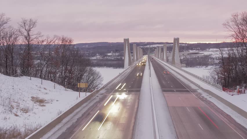 A Medium Shot on Traffic Driving Over the St. Croix Crossing Bridge between Minnesota and Wisconsin during a Dramatic Winter Sunset
