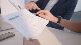 Business team analyzing analytics report paper together close up. Corporate worker holding financial data in hands and collaborating with coworkers in conference room - Powered by Shutterstock - Get 15% off with code: PIKWIZARD15