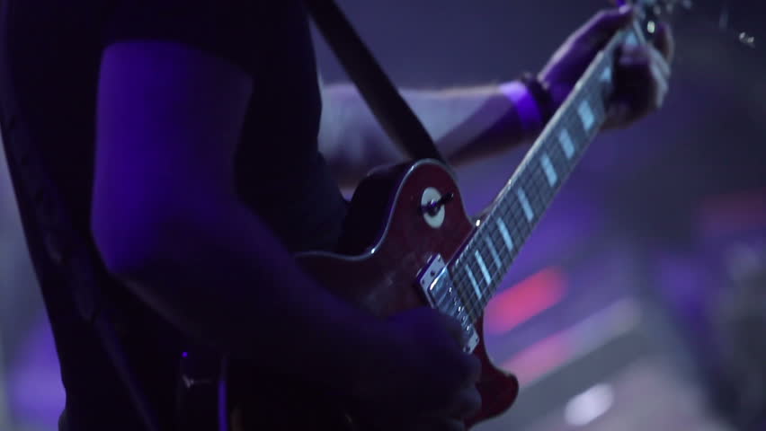 Guitar player on stage at a concert rocking the audience | Shutterstock HD Video #34365367