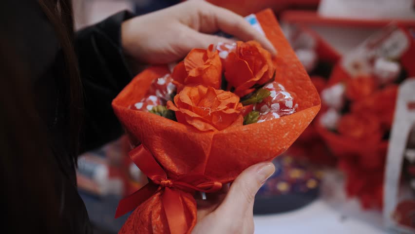 Valentine's Day. close-up. in hands. small romantic gift bouquet with heart-shaped sweets and red roses. festive decor, decorations for Valentine's Day. Love concept. Royalty-Free Stock Footage #3436560369