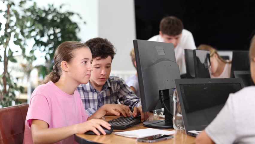 Curious underage girl and boy engaged in IT training during computer courses for children Royalty-Free Stock Footage #3436737857