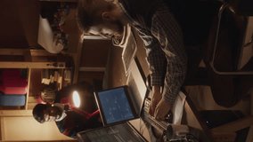 Vertical lowkey shot of ethnically diverse group of tech lovers creating software startup together, brainstorming and program coding in 90s style garage office - Powered by Shutterstock - Get 15% off with code: PIKWIZARD15