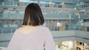 Slow-motion video of a 20-year-old Taiwanese female college student spending time in a beautiful library at a university in Wenshan District, Taipei 