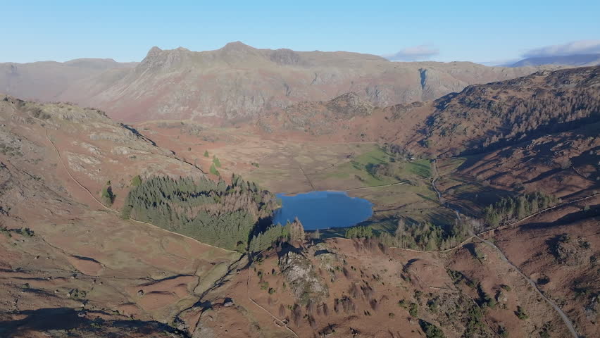 Aerial evening view over Blea Tarn and the Langdale Pikes, Lake District National Park, Cumbria, England
