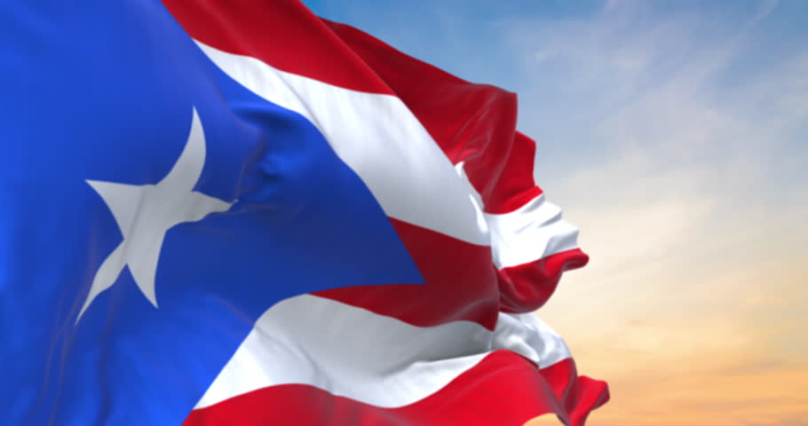 Detailed close up of the national flag of Puerto Rico waving in the wind on a sundown, seamless loop and slow motion animation