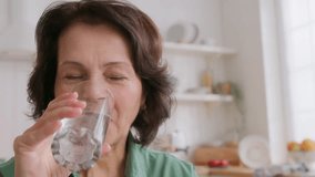 close up view of elderly woman holding pill on hand, takes medicine and drink water. feels good and positive, smiling. old people medicare - Powered by Shutterstock - Get 15% off with code: PIKWIZARD15